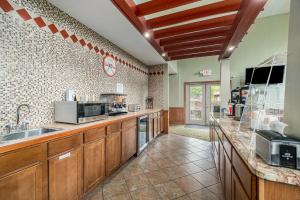 a large kitchen with a sink and a counter at Howard Johnson by Wyndham Traverse City in Traverse City