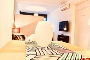 a room with a white chair in a room at One bedroom appartement at Torremolinos 900 m away from the beach with wifi in Torremolinos