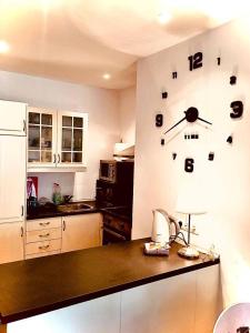 a kitchen with a clock on the wall at One bedroom appartement at Torremolinos 900 m away from the beach with wifi in Torremolinos