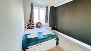 um quarto com uma cama com duas toalhas em Cosmo Suites em Bracknell