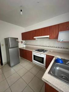 a kitchen with a refrigerator and a stove and a sink at Chaka2 in Tonalá
