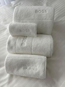 four towels stacked on top of each other on a bed at Center Park in Interlaken