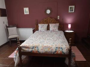 a bedroom with a bed with a wooden headboard at 2 bedrooms house with shared pool enclosed garden and wifi at Ponte de Lima in Ponte de Lima