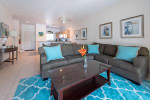 a living room with a couch and a table at Callie Kai at Kaibo Yacht Club in Driftwood Village