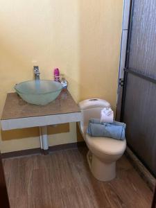 a bathroom with a sink and a toilet at Casa Sendero in Liberia