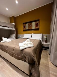 a bedroom with a large bed with towels on it at Esposito House in Sarno +10 photos