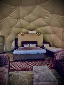 a bedroom with a bed in a tent at Pink Desert Camp in Wadi Rum