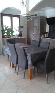 a kitchen with a table and chairs in a kitchen at Propriete de 2 chambres avec terrasse et wifi a Liginiac a 5 km de la plage in Liginiac
