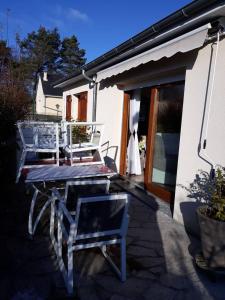 a patio with two chairs and a table and a table at Propriete de 2 chambres avec terrasse et wifi a Liginiac a 5 km de la plage in Liginiac