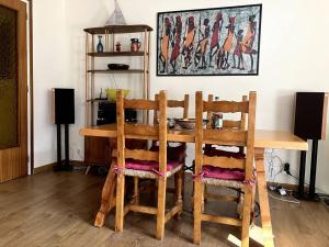 a wooden table and two chairs in a room at 2 bedrooms appartement with terrace and wifi at Arinsal in Mas de Ribafeta