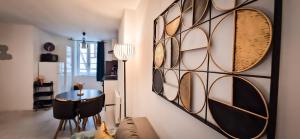 a living room with a wall of wine glasses at L'Art Déco 3 étoiles Wifi, Netflix, Disney, Coeur de Bastide in Villefranche-de-Rouergue