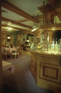 a restaurant with a bar with tables and chairs at Hotel und Restaurant Sackwitzer Mühle in Bad Schmiedeberg