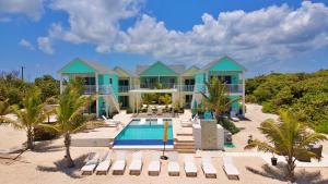 a house on the beach with a swimming pool at The Blue Iguana at Cottages in Sand Bluff