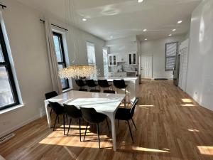 a dining room with a white table and chairs at Luxe Spacious SFH in Bucktown with Secure Parking in Chicago