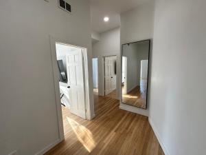 a hallway with two mirrors and a hard wood floor at Luxe Spacious SFH in Bucktown with Secure Parking in Chicago