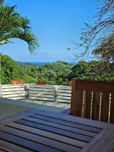 a wooden bench sitting in front of a fence at Casa Margarita in First Bight