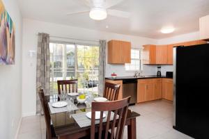 a kitchen and dining room with a table and chairs at Snug Harbour View Condo #3 in George Town