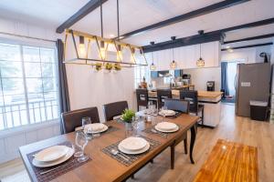 a dining room with a table and chairs and a kitchen at Bright Amazing 6 Bed Chalet Waterfront in Rigaud in Rigaud