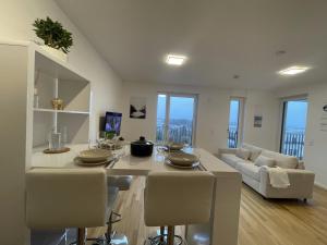 舍訥費德的住宿－Luxurious and stylish apartment at BER Airport，厨房以及带桌椅的起居室。