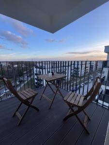 a table and chairs on a balcony with a view at Luxurious and stylish apartment at BER Airport in Schönefeld