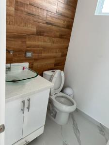 a bathroom with a toilet and a sink at CASA ESTRELLA in Puerto Peñasco +12 photos