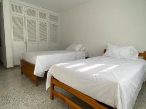 Postel nebo postele na pokoji v ubytování Apartamento Turismo en Ibagué ESMERALDA