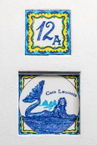 a sign for a restaurant with a mermaid on it at Casa Leucosia Suites in Capri