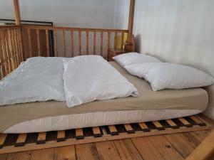 a bed with two white pillows on top of it at Agnieszki Room nr 1 in Krakow