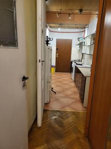a hallway of a kitchen with a door open at Agnieszki Room nr 1 in Krakow