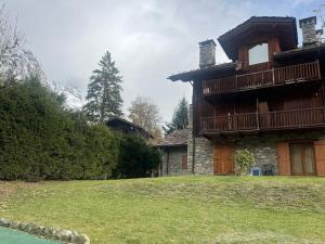a large house with a balcony on the side of it at Jack's House in Courmayeur