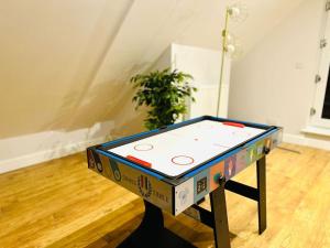 a ping pong table sitting on top of a table at SeaView Apartment with Roof Terrace and Pool Table in Kent