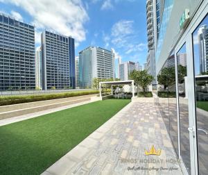 a lawn in the middle of a city with tall buildings at Reva residence suite burj Khalifa view ,Kings in Dubai