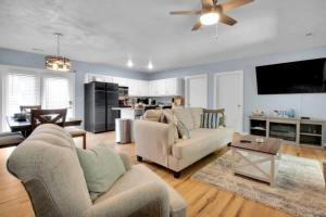 a living room with two couches and a ceiling fan at Modern 4BR House in Bloomington in Bloomington