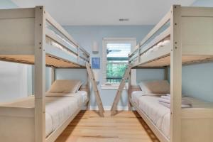 two bunk beds in a room with a window at Modern 4BR House in Bloomington in Bloomington +77 photos