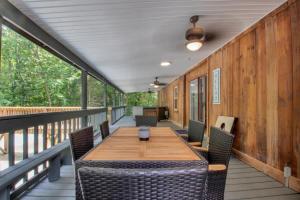 a deck with a wooden table and chairs at Modern 4BR House in Bloomington in Bloomington