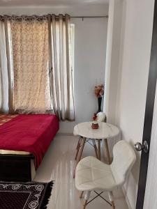 1 dormitorio con 1 cama, 1 mesa y 1 silla en Avena 2BHK Swami Apartment Jail Road Nashik, en Nashik