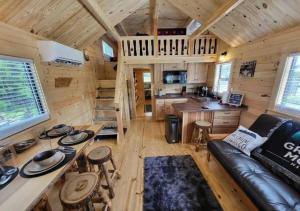 a living room and kitchen in a log cabin at Picturesque Family Cabin with Loft in Tennessee in Sevierville