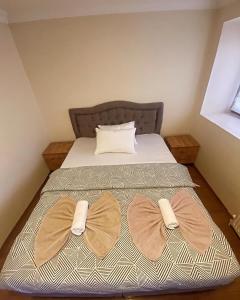 two bow ties on a bed in a room at Eylül suit otel in Yıldırım