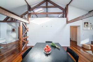 a dining room with a black table with a bowl of fruit at PedrasNegras30 Lisbon Lofts & Apartments in Lisbon