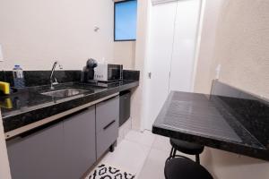 a kitchen with a sink and a counter top at Loft Coração da Serra in Serra Negra +12 photos
