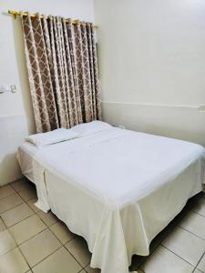 Private Rooms In Osu في آكرا: سرير ابيض في غرفه ستاره