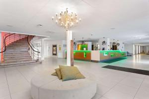 a large lobby with a couch and a chandelier at Best Western Plus Skogshöjd in Södertälje