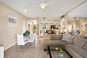 a living room and dining room with a couch and a table at Midnights at the Oasis in Cathedral City