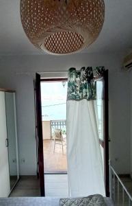 a room with a bed and a chandelier at Joković Accommodation in Kotor