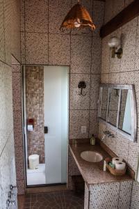 a bathroom with a sink and a mirror at Pousada Estalagem Mirante in Aiuruoca