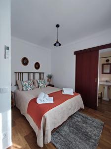 a bedroom with a bed with two towels on it at Casa Tia Xica in Monsaraz +21 photos