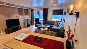 a living room with a couch and a table at Otnes Fjordside in Aurland