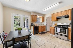 a kitchen with a table and a stove top oven at Cottage in Diamondhead in Diamondhead