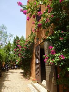 a building with flowers on the side of it at Hotel de la Liberte in Ouagadougou