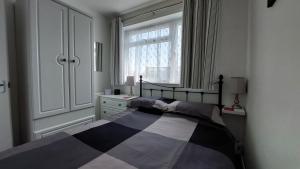 a bedroom with a bed and a window at Sunny View, 87 Brambles Chine in Freshwater